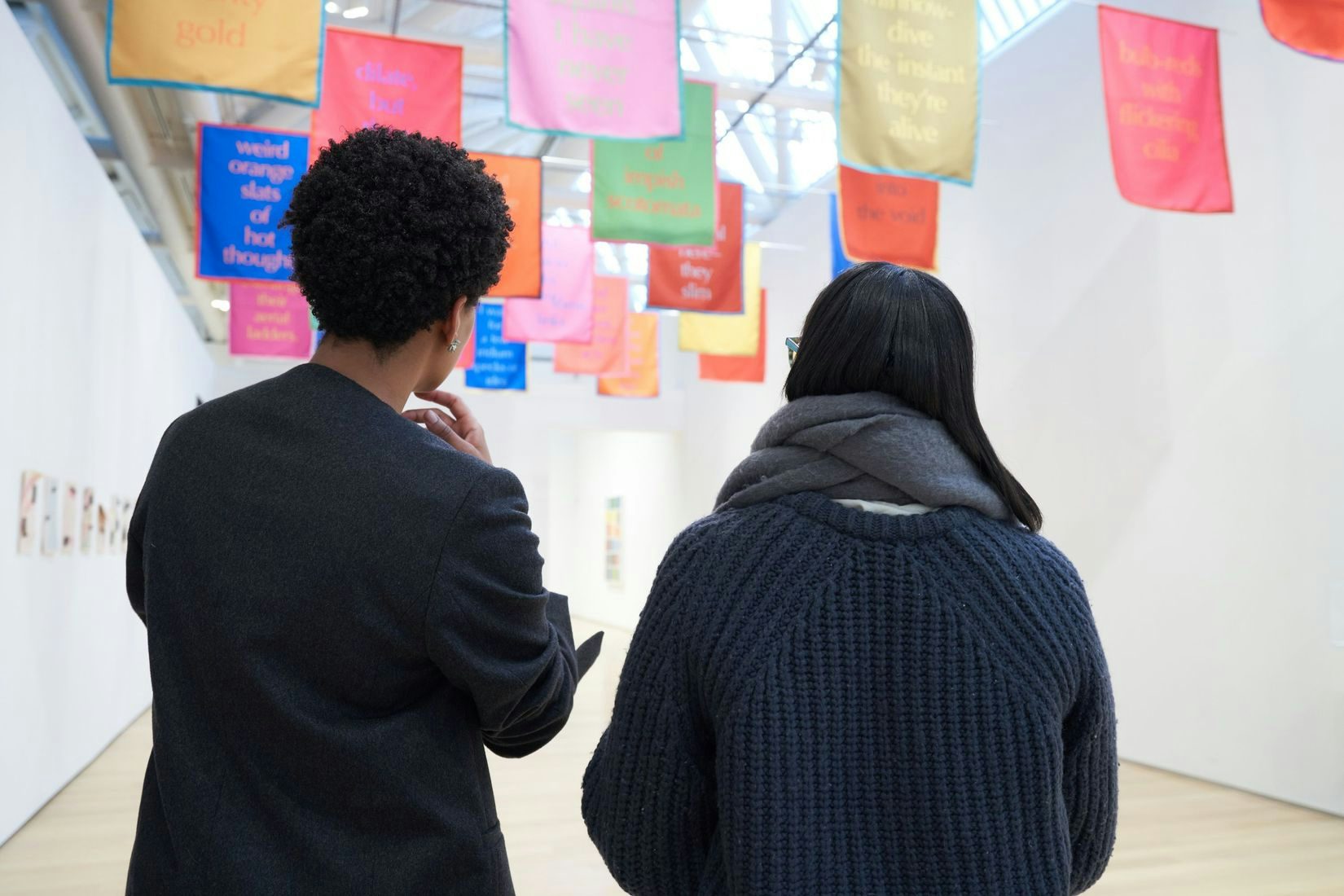 Two people looking at an exhibition.